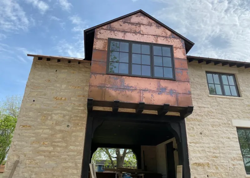 Copper metal panel facade on a stone building for Skylight Installation in Scottdale